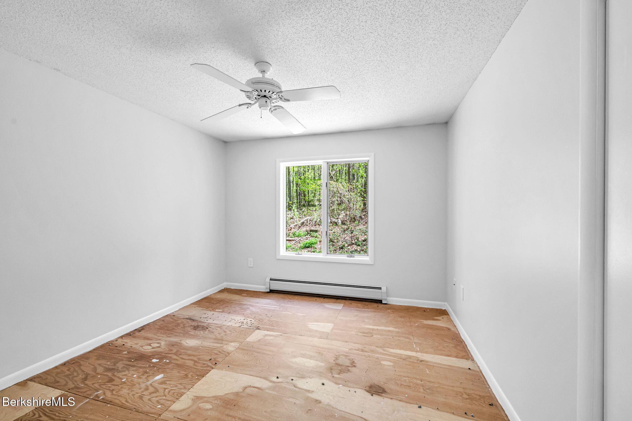 1874 Home Road Sheffield, MA 01230 - Photo 23 of 42 an empty room with a window and a fan