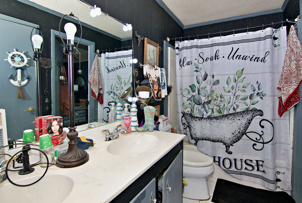 41 3rd Avenue Iva, SC 29655 - Photo 13 of 31 This bathroom features a double vanity and sleek countertops, providing ample space and convenience.