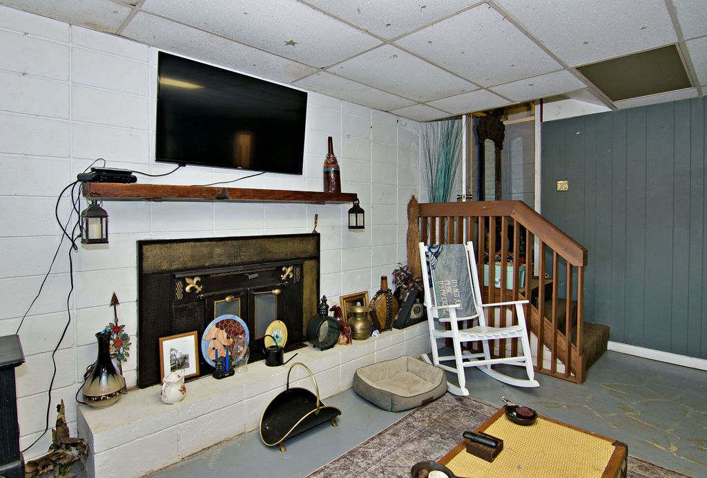 41 3rd Avenue Iva, SC 29655 - Photo 17 of 31 This living space features a cozy fireplace, ideal for relaxed gatherings and quiet evenings.