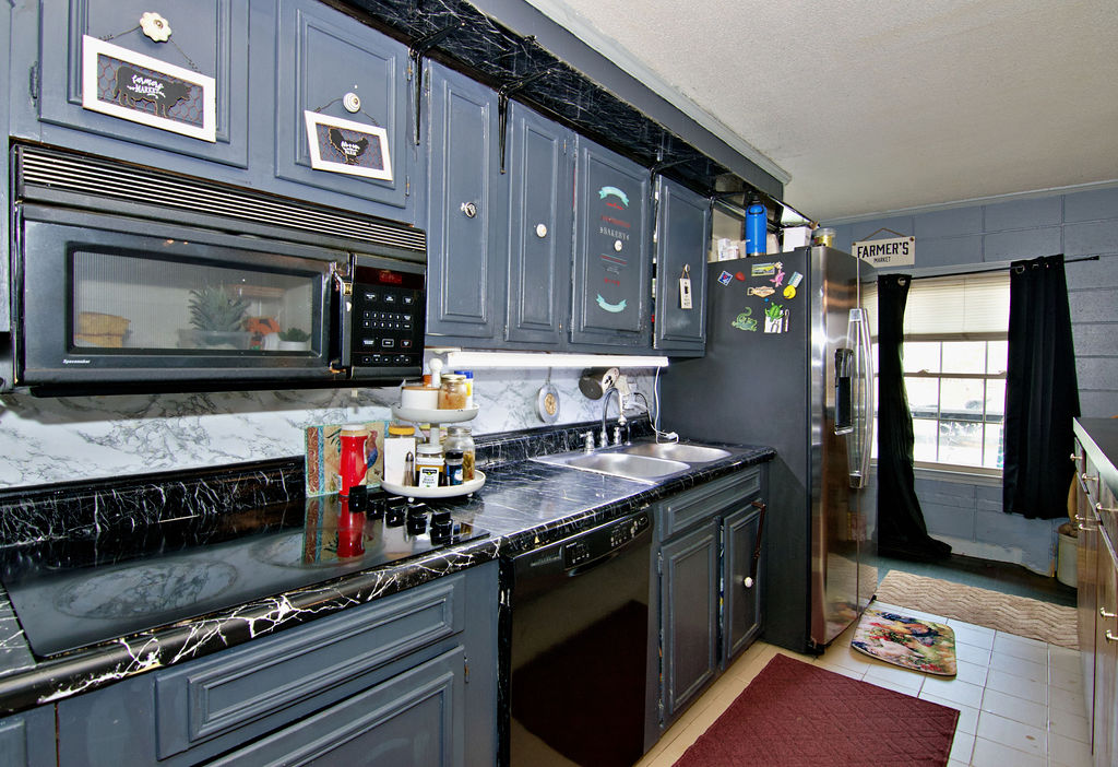 41 3rd Avenue Iva, SC 29655 - Photo 6 of 31 This cozy kitchen features a practical layout with dark cabinetry and ample counter space.
