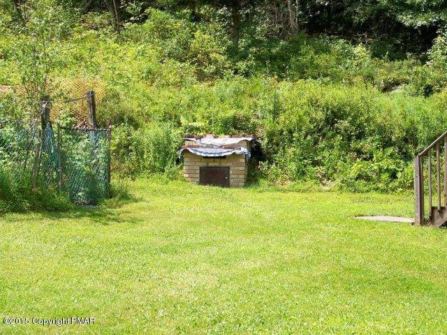 259 Devils Hole Road Cresco, PA 18326 - Photo 19 of 20 a view of a backyard with table and chairs and potted plants
