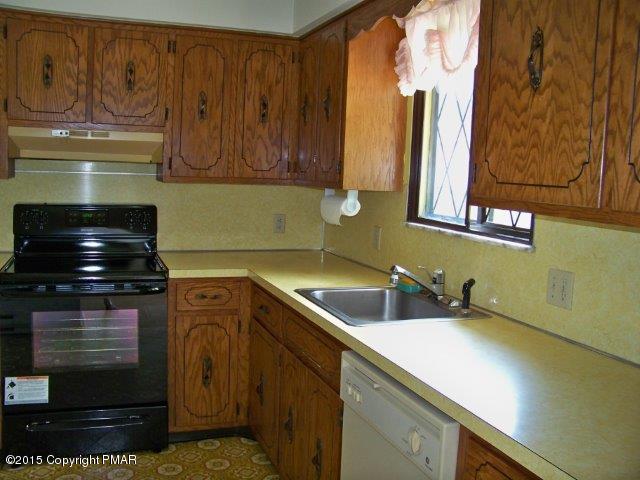 259 Devils Hole Road Cresco, PA 18326 - Photo 6 of 20 a kitchen with a sink and cabinets