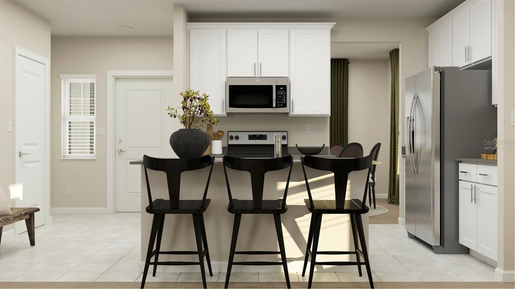 6072 Zen Way Clermont, FL 34714 - Photo 2 of 21 a view of a dining room with furniture and a refrigerator