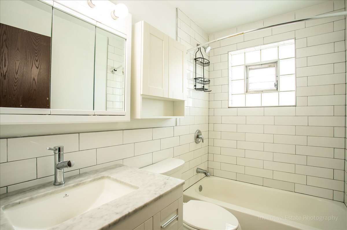 7345 West 85th Place, Unit 3A Bridgeview, IL 60455 - Photo 11 of 21 a bathroom with a granite countertop sink toilet and shower