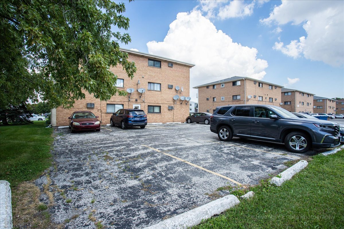 7345 West 85th Place, Unit 3A Bridgeview, IL 60455 - Photo 18 of 21 a car parked in front of a house