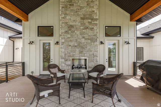 1188 South Old Trappers Loop Road Huntsville, UT 84317 - Photo 65 of 92 Expansive covered patio featuring a stone fireplace with a built-in firebox, exposed wood beams, and composite decking