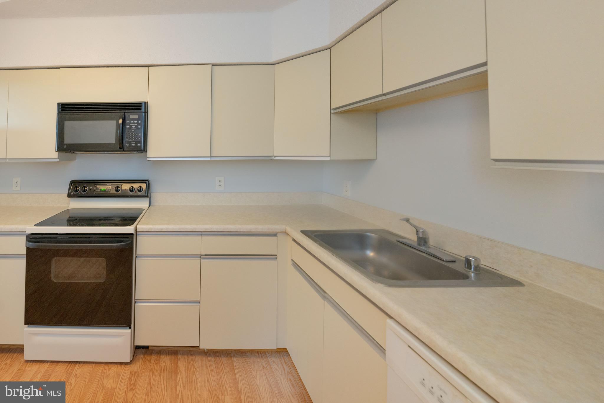 5501 Seminary Road, Unit 1113S Falls Church, VA 22041 - Photo 13 of 43 a kitchen with stainless steel appliances granite countertop a sink a stove and microwave