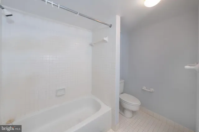 a bathroom with a tub sink vanity and a mirror