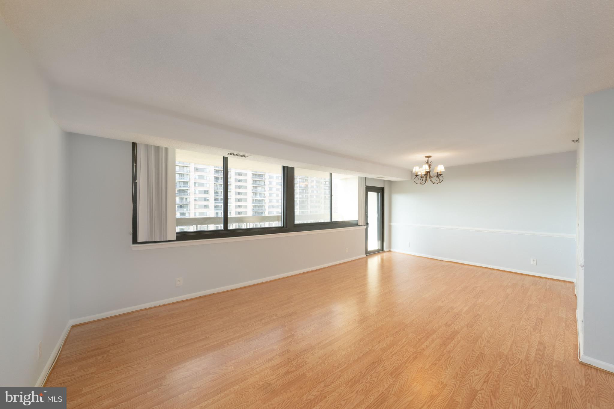 5501 Seminary Road, Unit 1113S Falls Church, VA 22041 - Photo 26 of 43 an empty room with wooden floor and windows