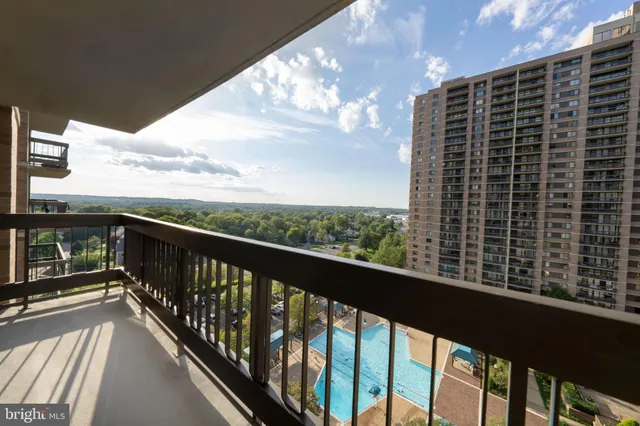 a balcony with furniture and potted plants