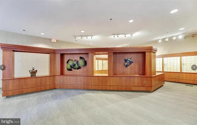 a living room with lots of furniture and a floor to ceiling window