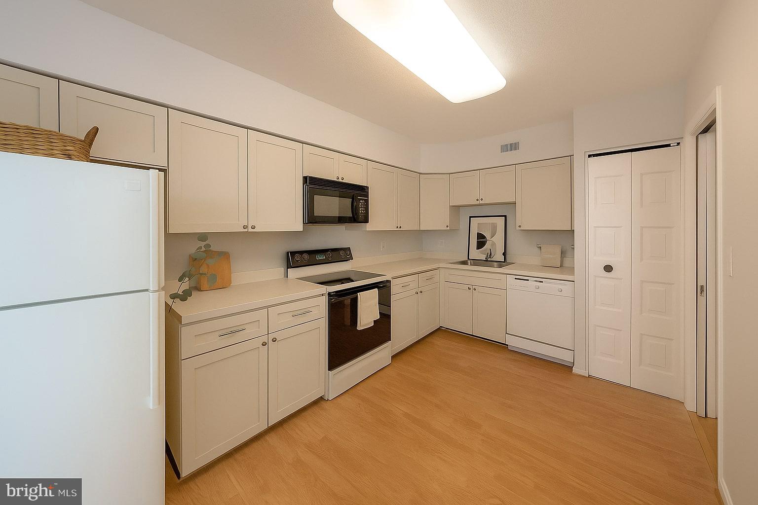 5501 Seminary Road, Unit 1113S Falls Church, VA 22041 - Photo 4 of 43 a kitchen with white cabinets and white appliances