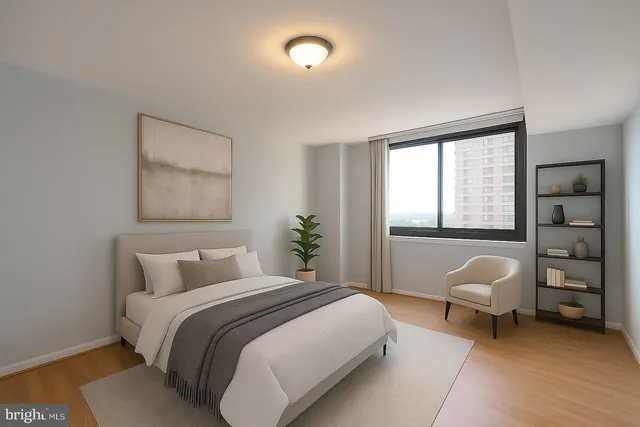 a bedroom with a bed and a large window