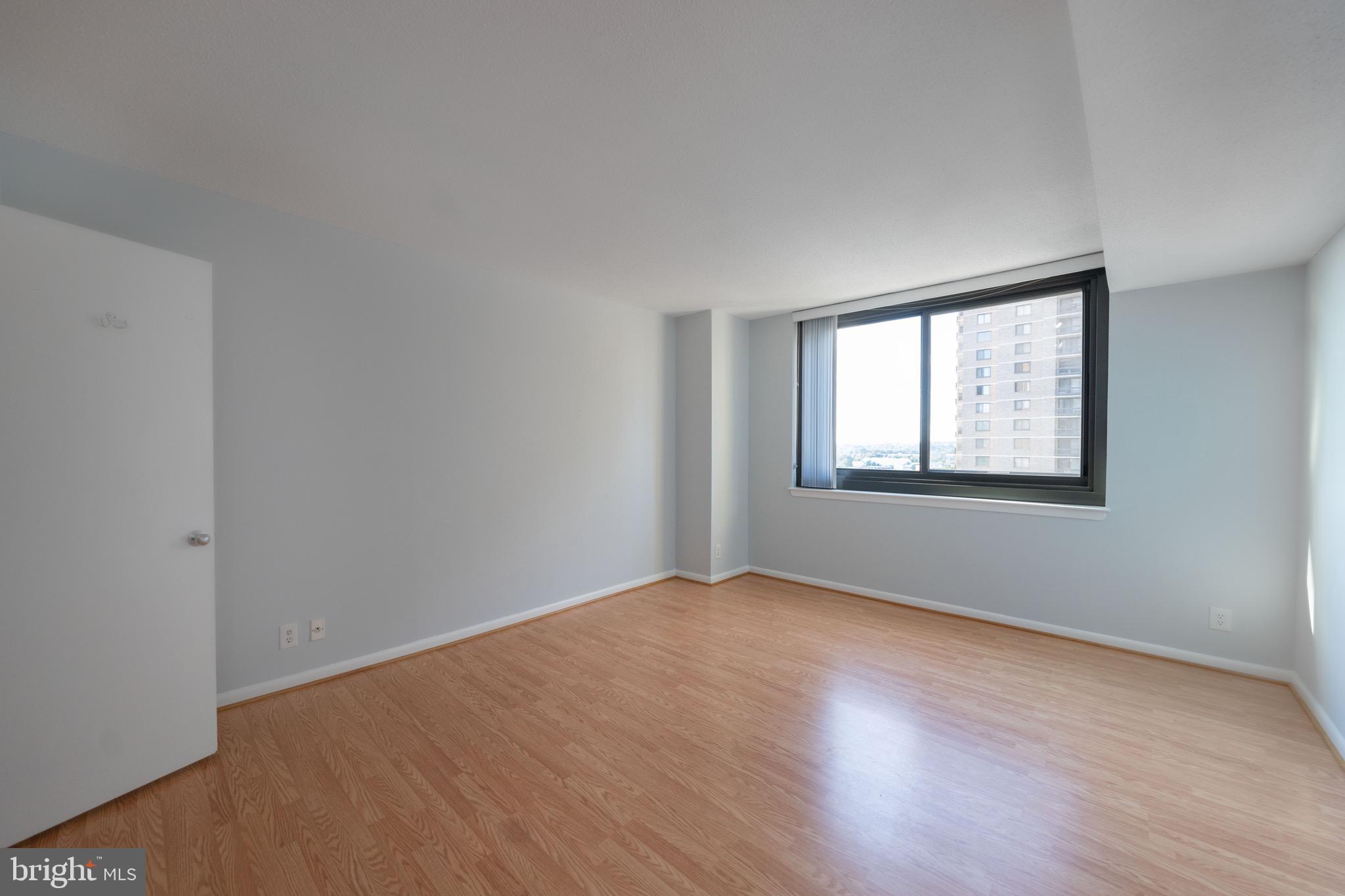 5501 Seminary Road, Unit 1113S Falls Church, VA 22041 - Photo 8 of 43 a view of an empty room with wooden floor and a window
