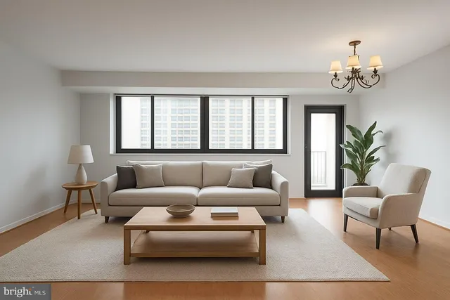 a living room with furniture a chandelier and a window