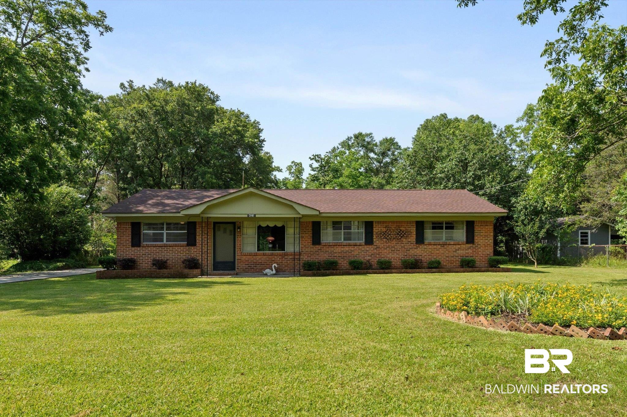 423 First Avenue Saraland, AL 36571 - Photo 1 of 20 Ranch-style home featuring a front lawn and brick siding