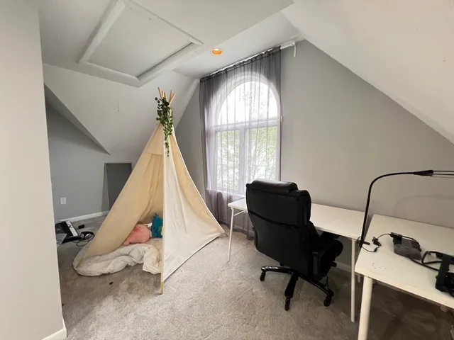 a room with gym equipment and windows