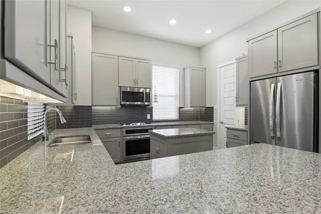 a view of a patio with a table and chairs and potted plants