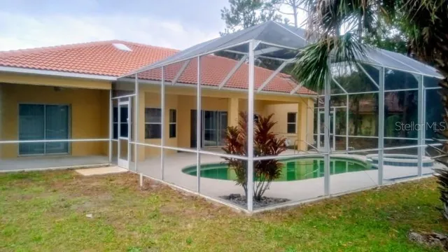 a view of a swimming pool with a yard