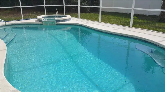 a living room with furniture a computer on the desk and chair