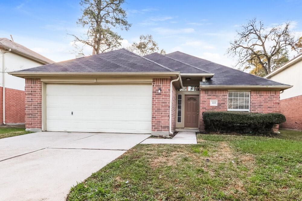 3219 Candlepine Drive Spring, TX 77388 - Photo 1 of 16 a front view of a house with a garden and yard