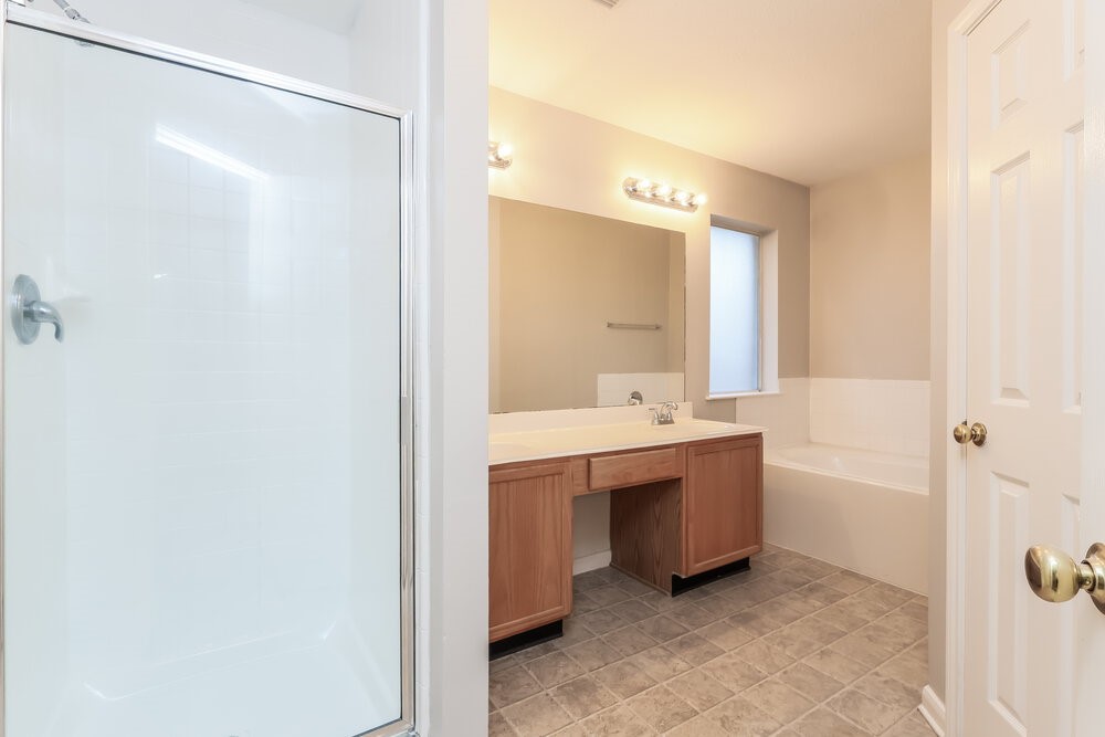 3219 Candlepine Drive Spring, TX 77388 - Photo 12 of 16 a bathroom with a bathtub sink vanity and mirror