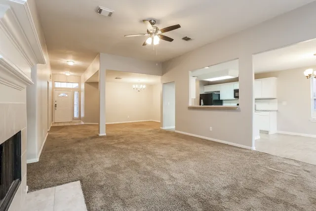 an empty room with mirror and entrance