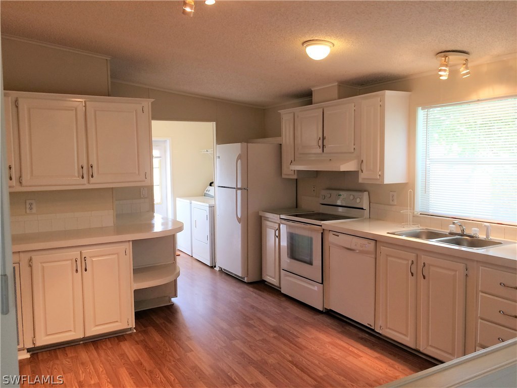 11331 Long Road Fort Myers, FL 33905 - Photo 6 of 24 a kitchen with granite countertop white cabinets and white appliances