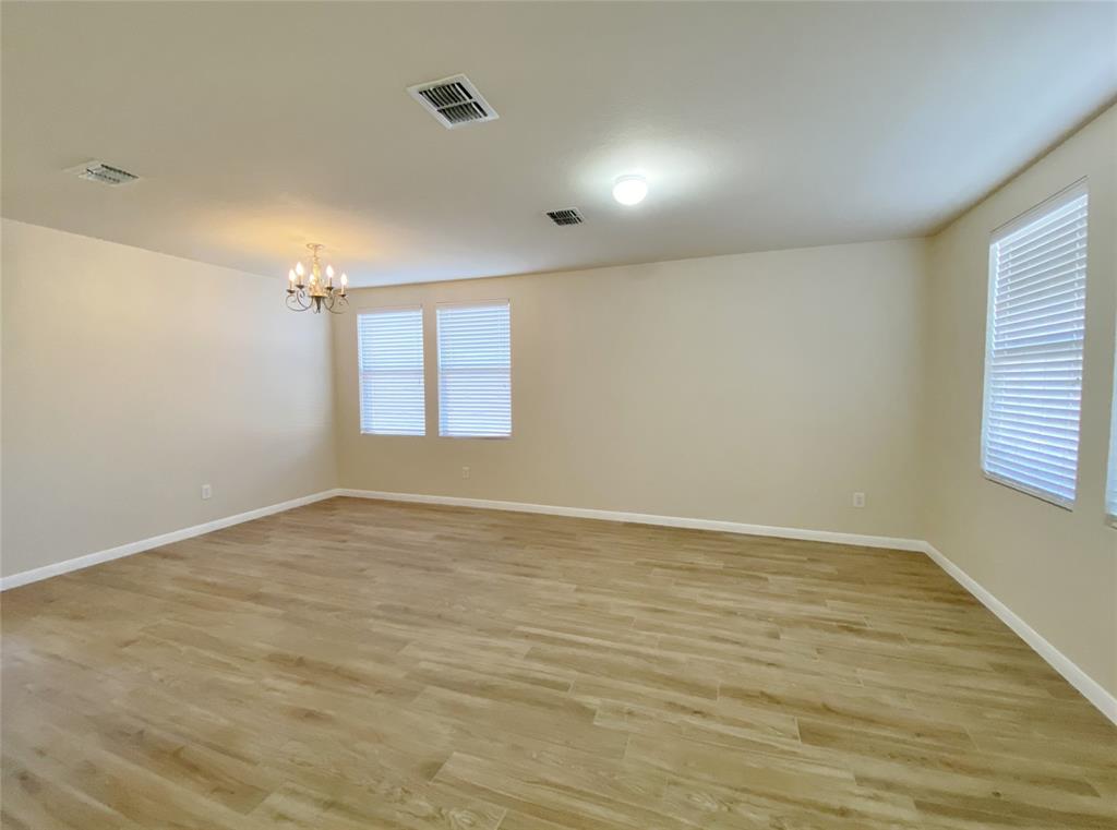 5511 Green Ivy Road Denton, TX 76210 - Photo 2 of 12 wooden floor in an empty room with a window