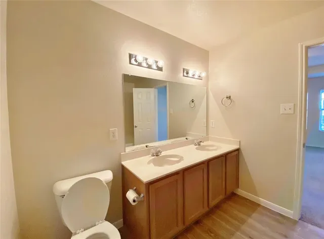 a bathroom with a toilet sink and mirror