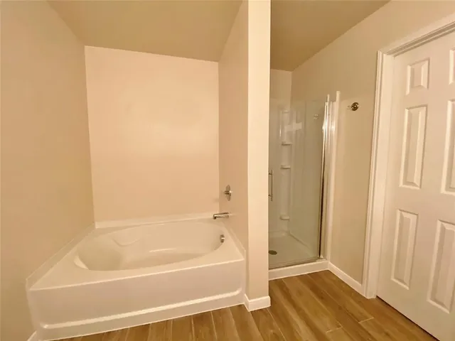 a bathroom with a bathtub and a shower