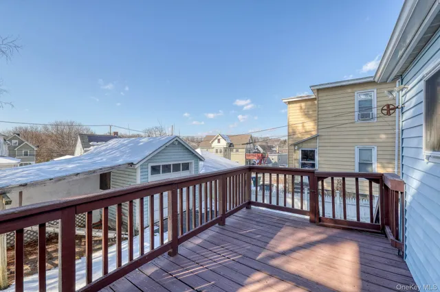 a view of a balcony with wooden floor