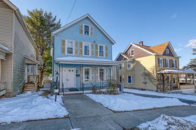 a front view of a house with yard porch and outdoor seating