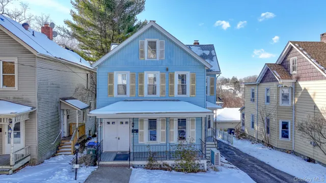 a view of a brick house with table and chairs and wooden floor