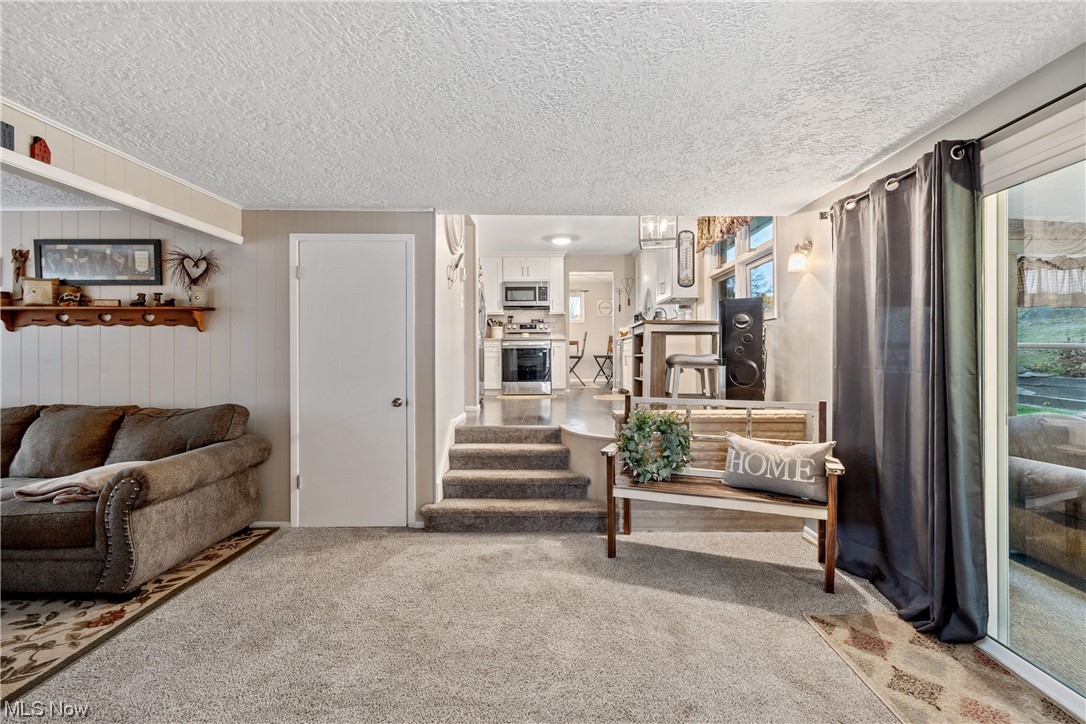 5369 Ridge Avenue Southeast Canton, OH 44707 - Photo 13 of 33 Living room with a textured ceiling and carpet flooring