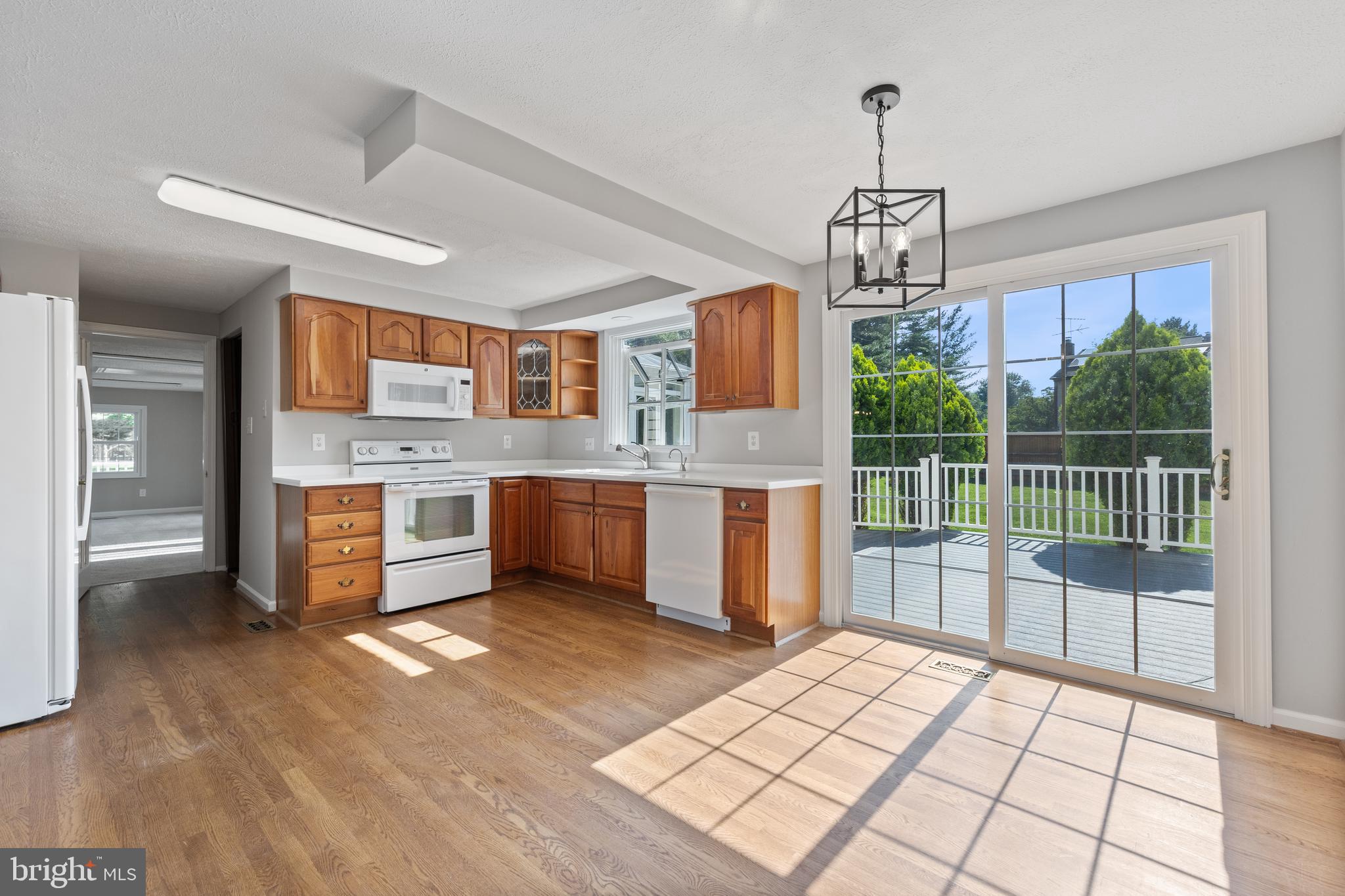 22000 Goshen School Road Gaithersburg, MD 20882 - Photo 17 of 57 a open kitchen with stainless steel appliances granite countertop a stove top oven a sink dishwasher a dining table and chairs with wooden floor