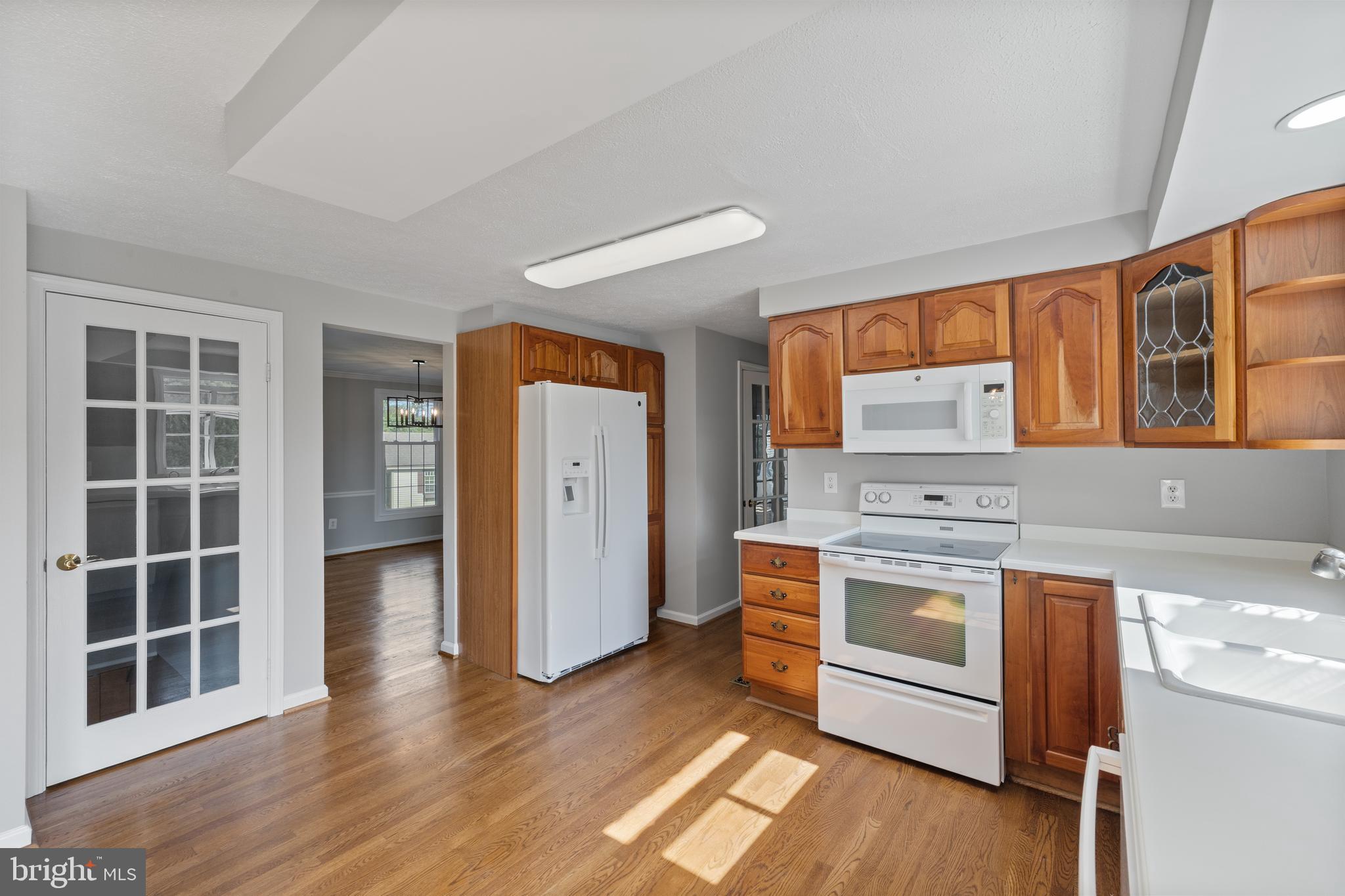 22000 Goshen School Road Gaithersburg, MD 20882 - Photo 19 of 57 an empty room with wooden floor and cabinets