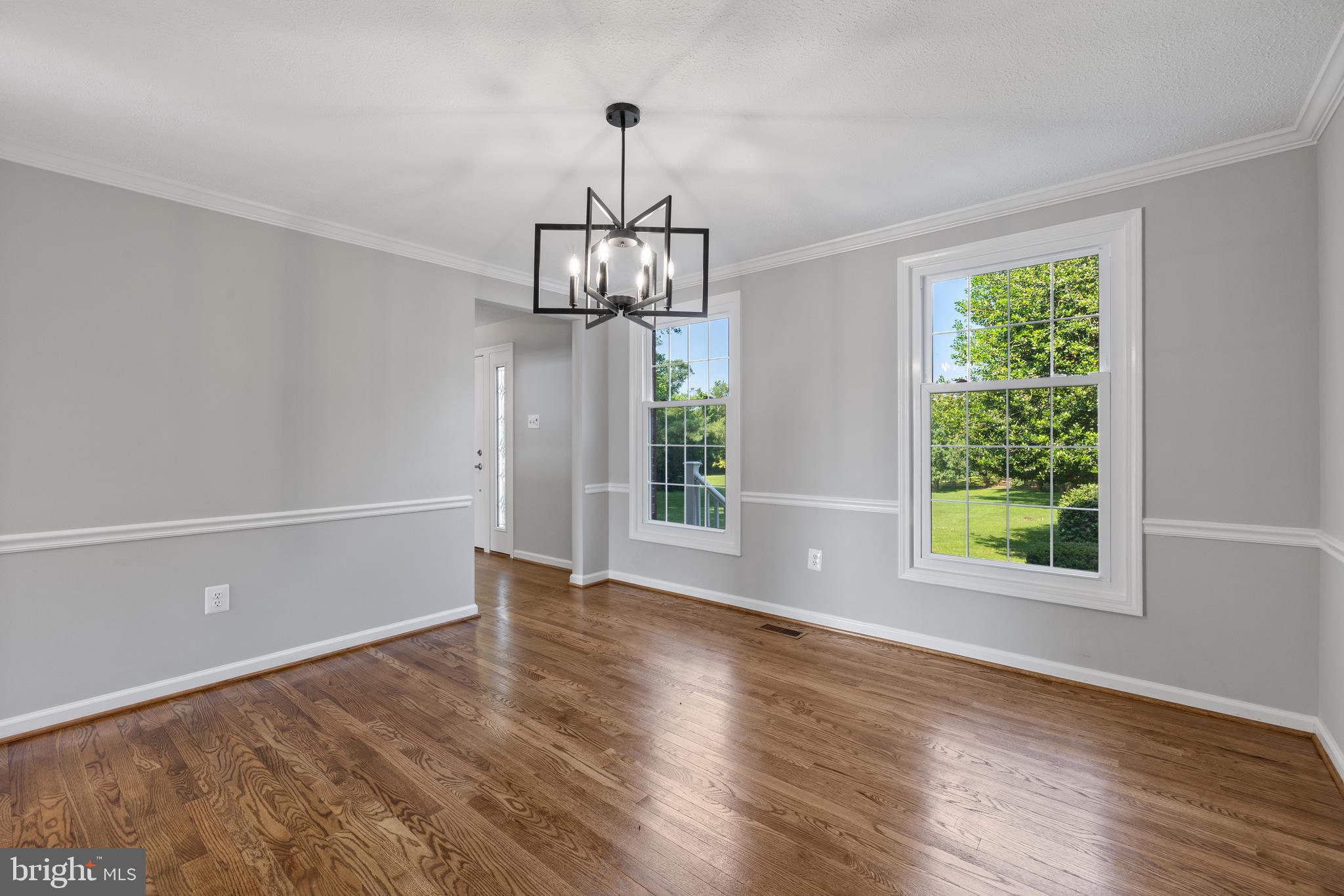 22000 Goshen School Road Gaithersburg, MD 20882 - Photo 24 of 57 a view of an empty room with wooden floor exposed radiator and a window