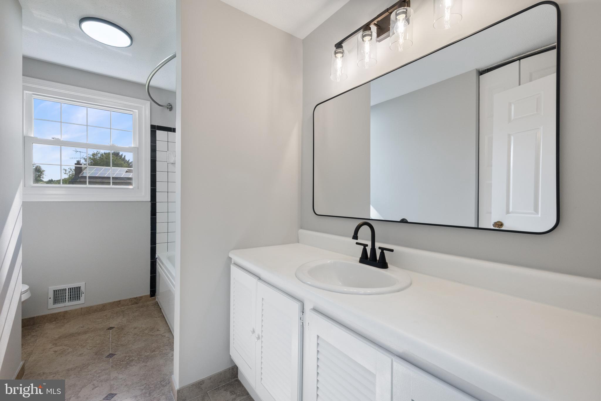 22000 Goshen School Road Gaithersburg, MD 20882 - Photo 38 of 57 a bathroom with a sink and a mirror