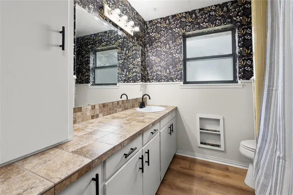 a backyard of a house with table and chairs