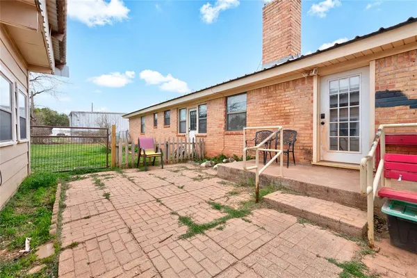 a backyard of a house with lots of green space and fountain