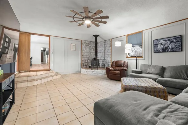 a view of a livingroom with furniture and a window