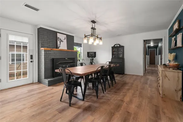 a kitchen with cabinets and wooden floor