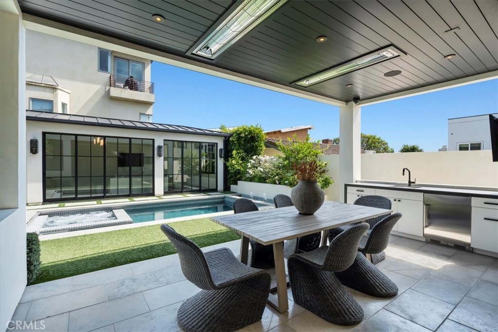 604 14th Street Manhattan Beach, CA 90266 - Photo 19 of 43 a view of a patio with table and chairs and potted plants