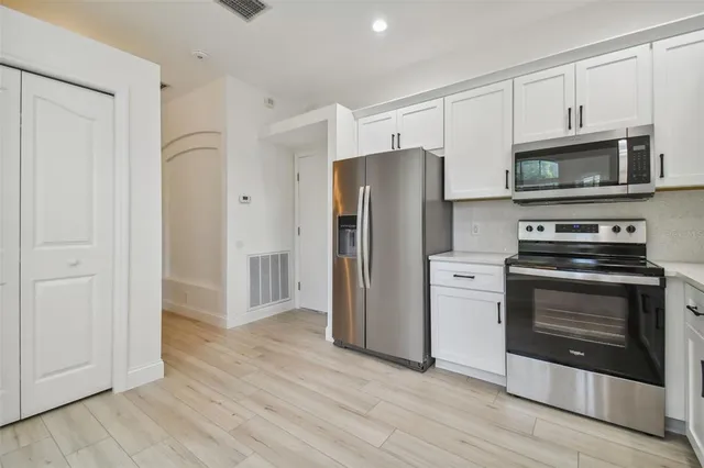 a bathroom with a granite countertop toilet a sink and a mirror