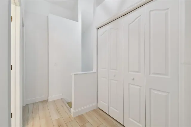 a view of an empty room with wooden floor