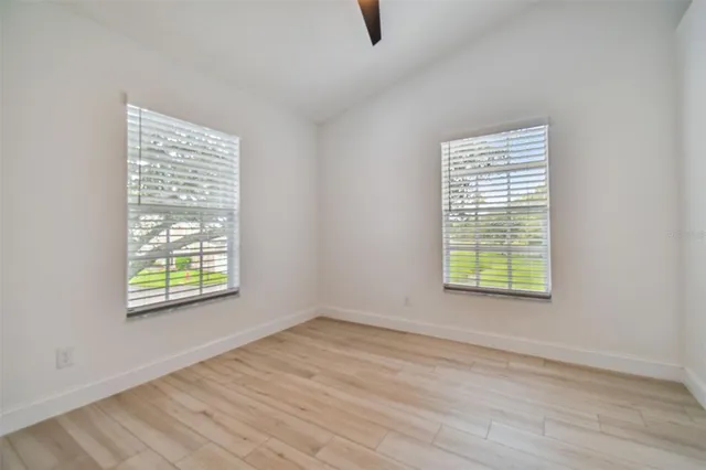a view of balcony with wooden floor and fence