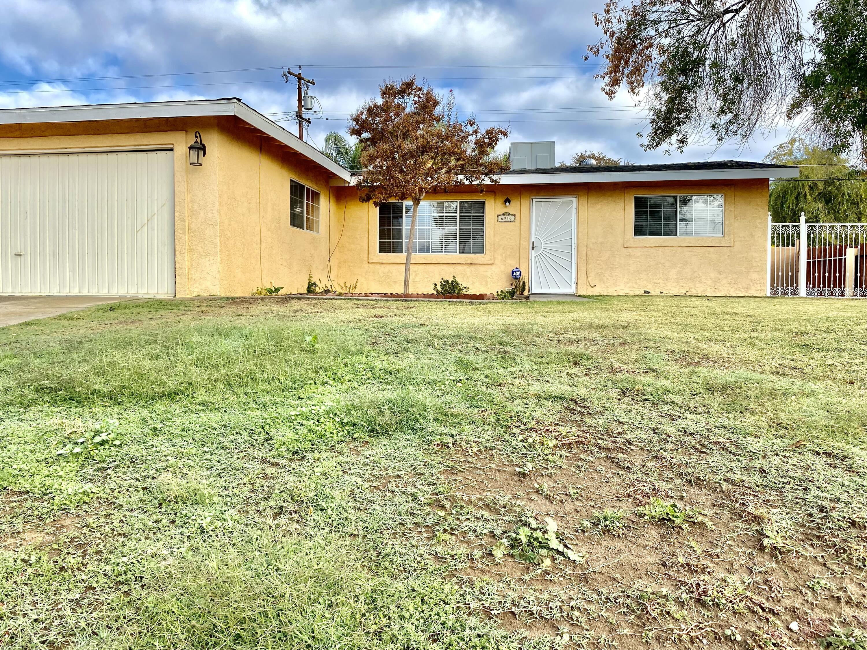 a view of a house with a backyard and garden