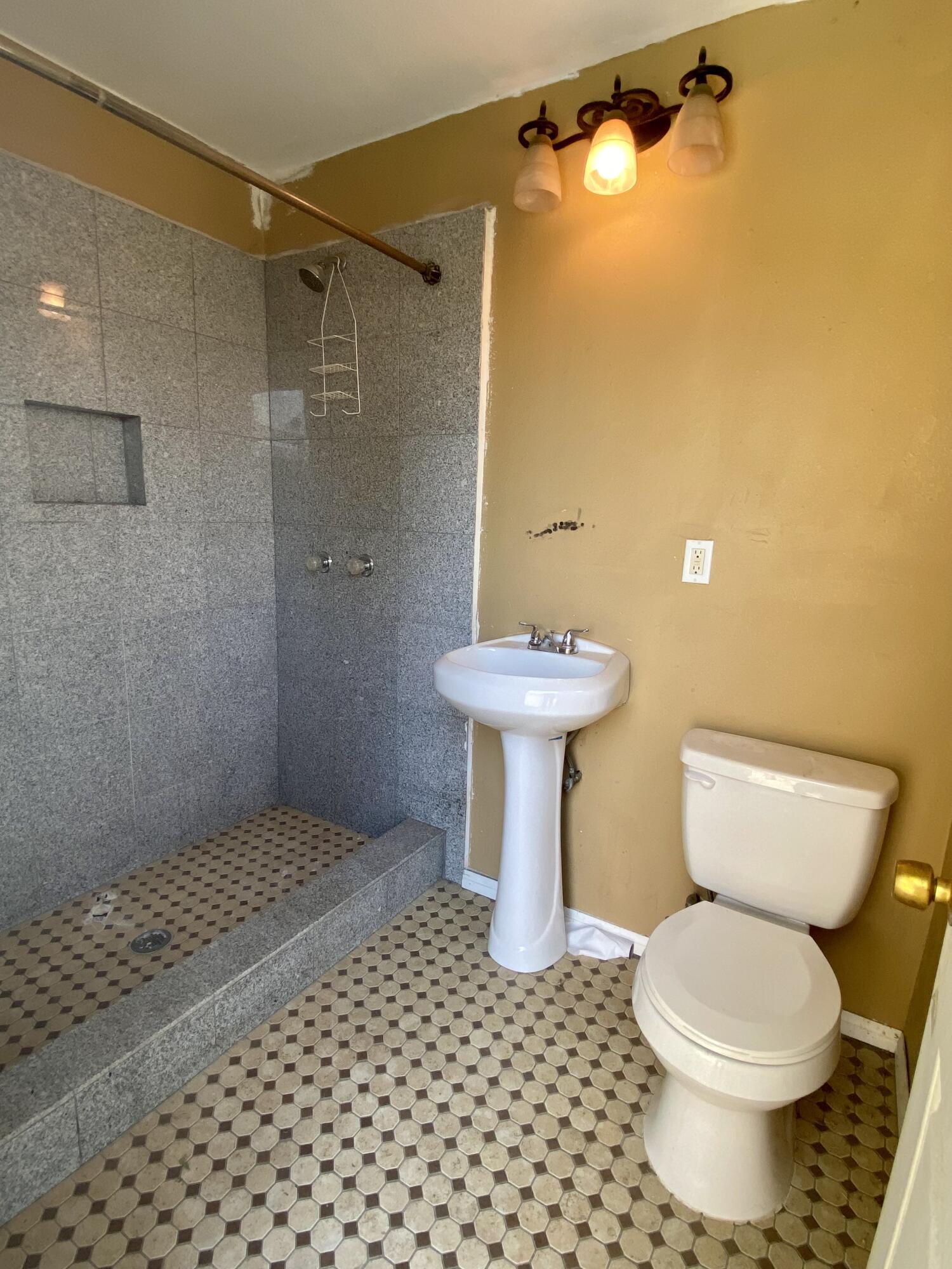 6916 Azalea Avenue Bakersfield, CA 93306 - Photo 16 of 26 a bathroom with a shower toilet and sink