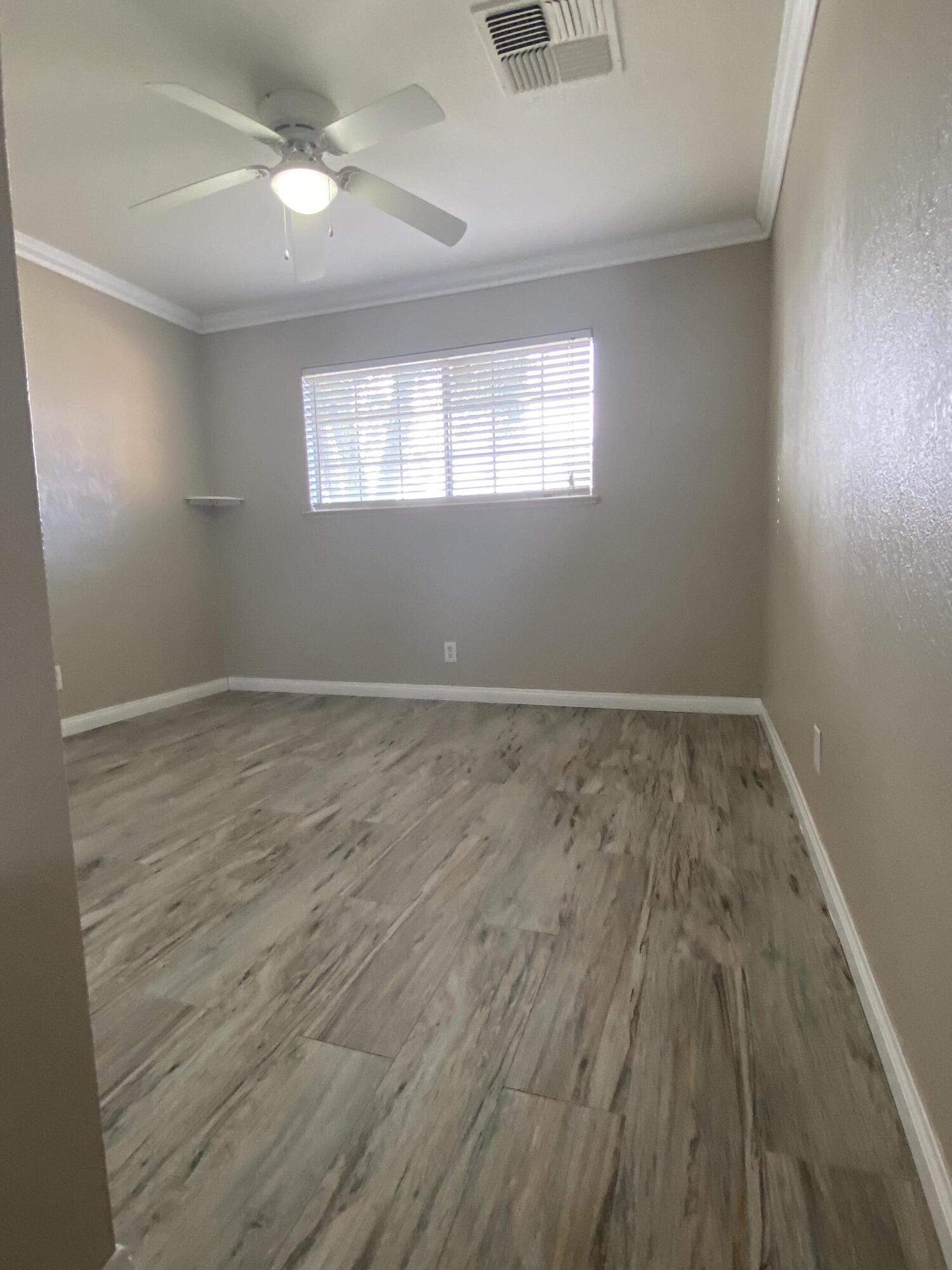 6916 Azalea Avenue Bakersfield, CA 93306 - Photo 9 of 26 wooden floor in an empty room with a window